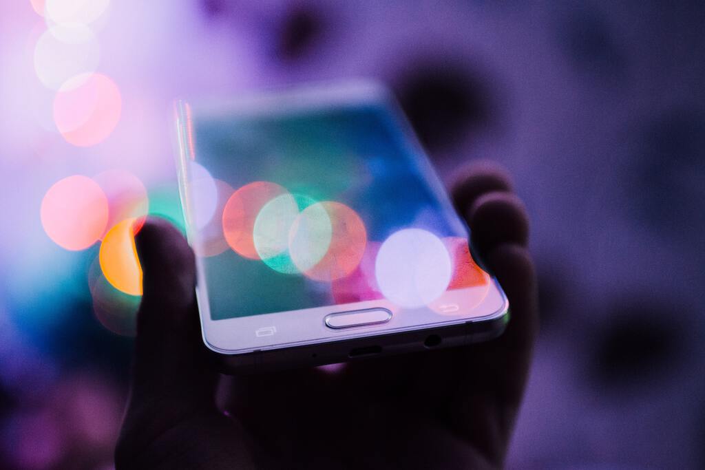 Person holding their phone to the sky